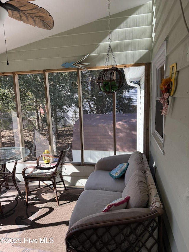 sunroom featuring vaulted ceiling