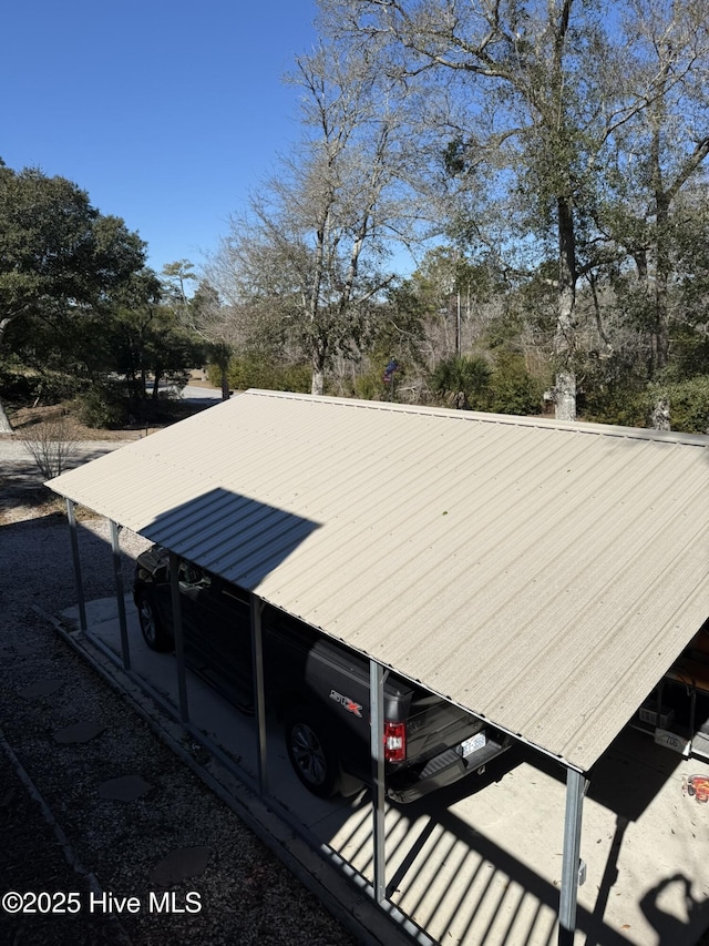 view of side of home featuring metal roof and a carport