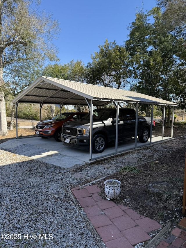 view of parking / parking lot with gravel driveway and a detached carport