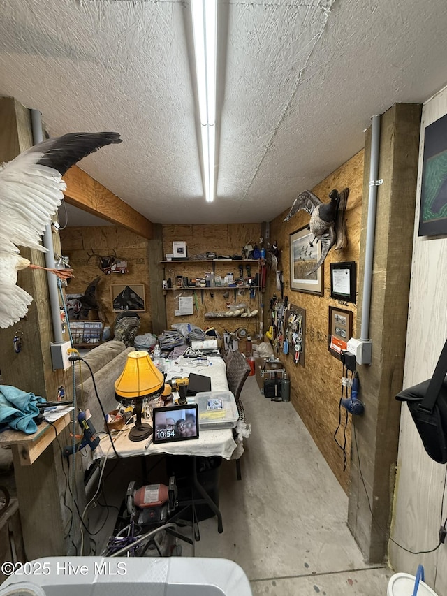 interior space featuring concrete floors, a textured ceiling, and a workshop area