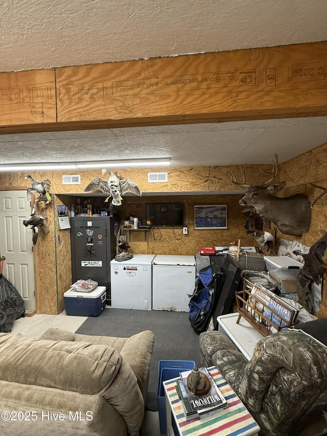 living room with beam ceiling and visible vents