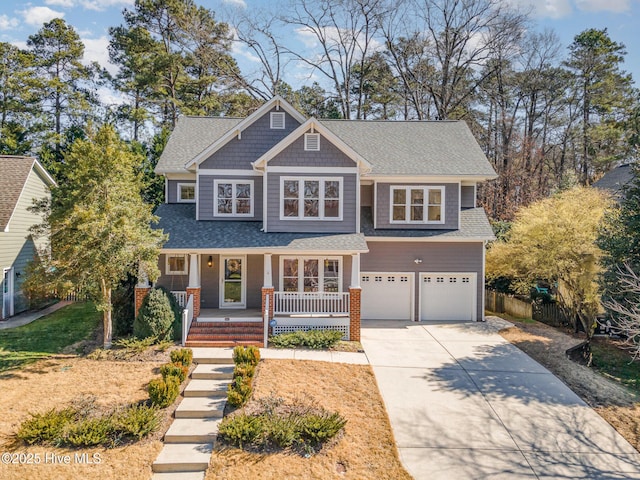 view of front facade with covered porch, a garage, fence, driveway, and roof with shingles