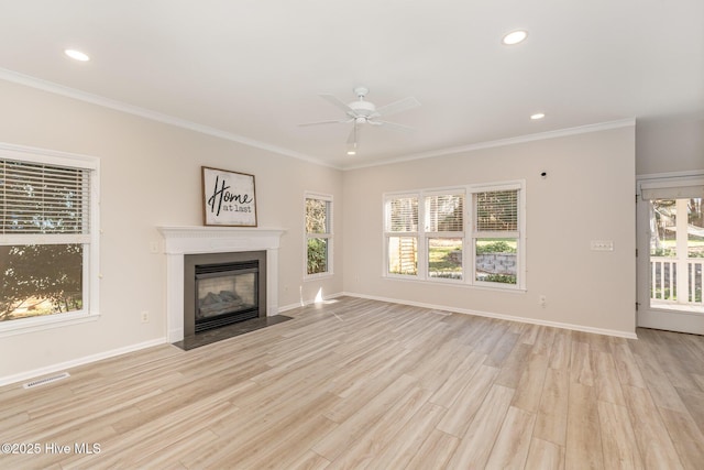 unfurnished living room with a fireplace with flush hearth, visible vents, baseboards, and wood finished floors