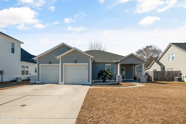 view of front of home featuring cooling unit, a garage, fence, concrete driveway, and a front yard