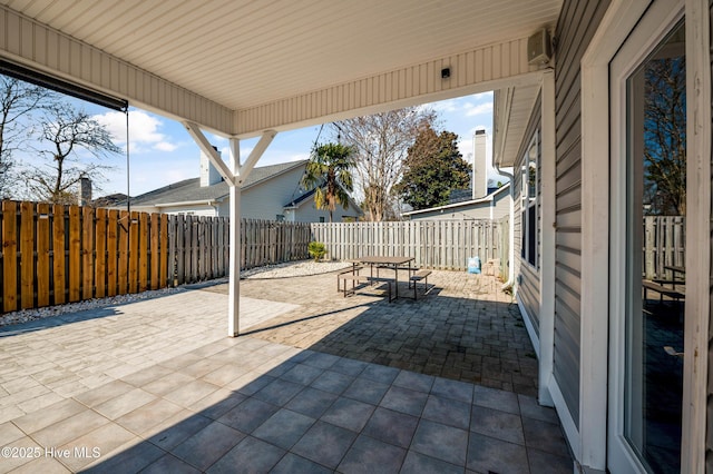 view of patio with a fenced backyard and outdoor dining area