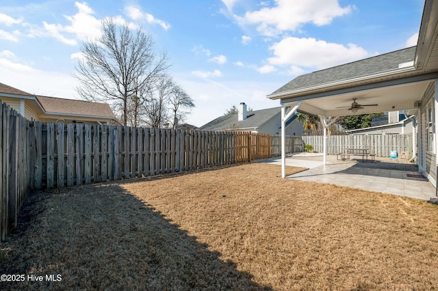 view of yard featuring a fenced backyard, ceiling fan, and a patio