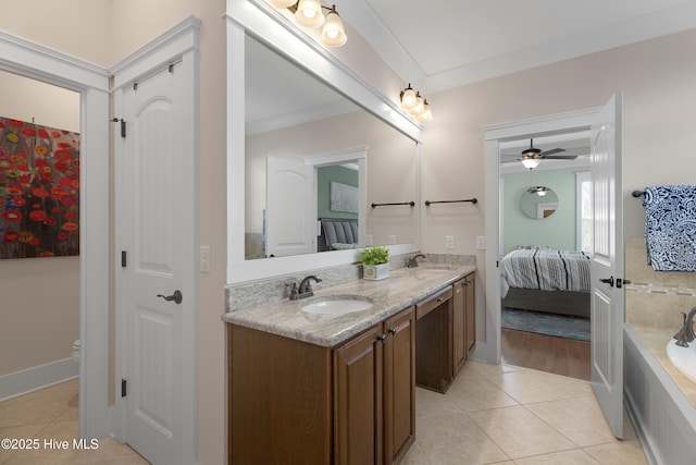 ensuite bathroom featuring double vanity, a sink, and tile patterned floors