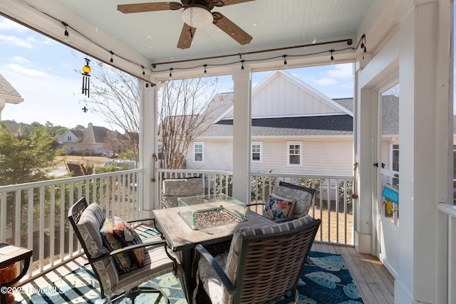 deck with ceiling fan and a fire pit