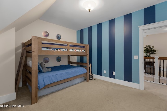 carpeted bedroom with lofted ceiling, wallpapered walls, and baseboards