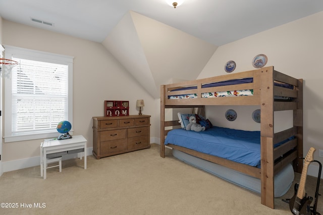 bedroom with lofted ceiling, baseboards, visible vents, and carpet flooring