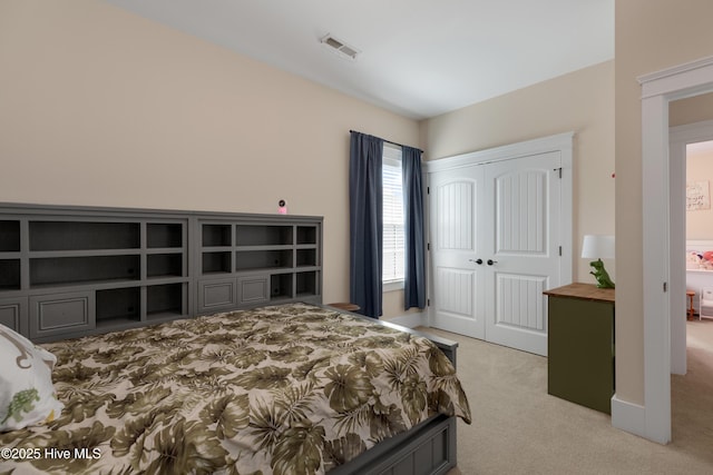 bedroom featuring light colored carpet, a closet, and visible vents