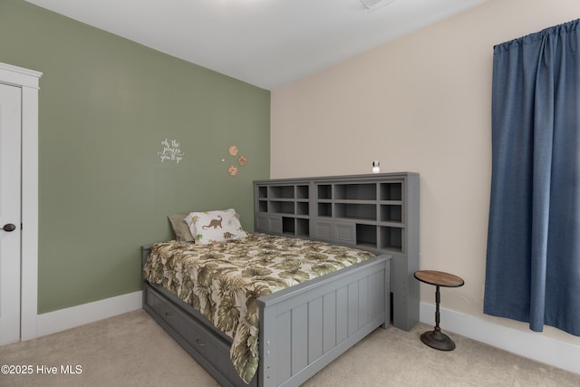 bedroom with light carpet, visible vents, and baseboards