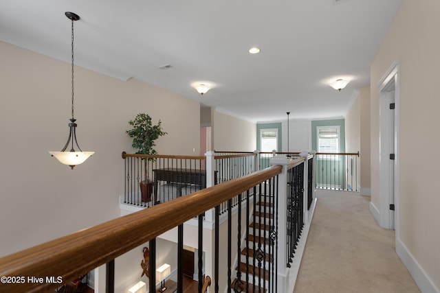 corridor with recessed lighting, light colored carpet, an upstairs landing, baseboards, and visible vents