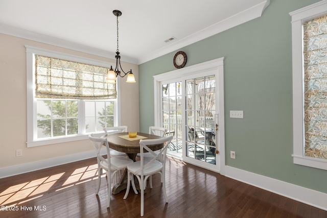 dining space with visible vents, baseboards, dark wood-type flooring, and ornamental molding