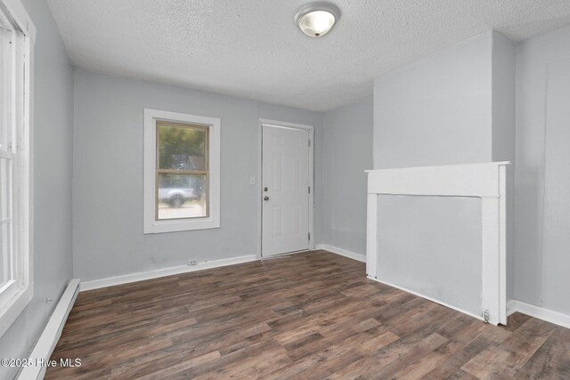 foyer featuring a textured ceiling, a baseboard radiator, wood finished floors, and baseboards