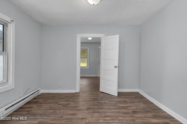 empty room with a baseboard radiator, a textured ceiling, baseboards, and dark wood-type flooring