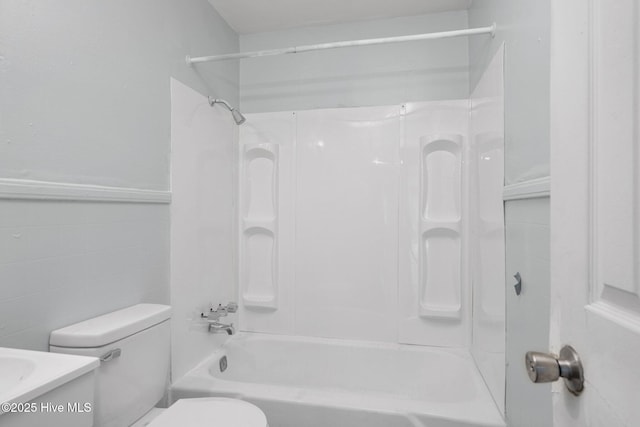 bathroom featuring bathtub / shower combination, tile walls, toilet, and vanity