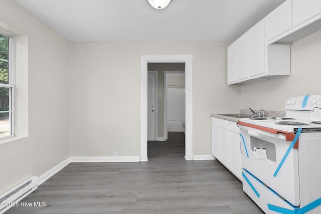 kitchen with white range with electric stovetop, light wood-style flooring, a baseboard heating unit, white cabinetry, and baseboards