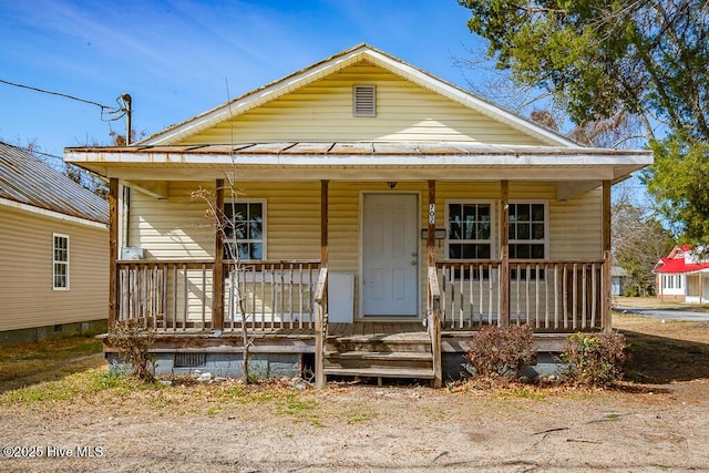 bungalow-style home with covered porch and crawl space