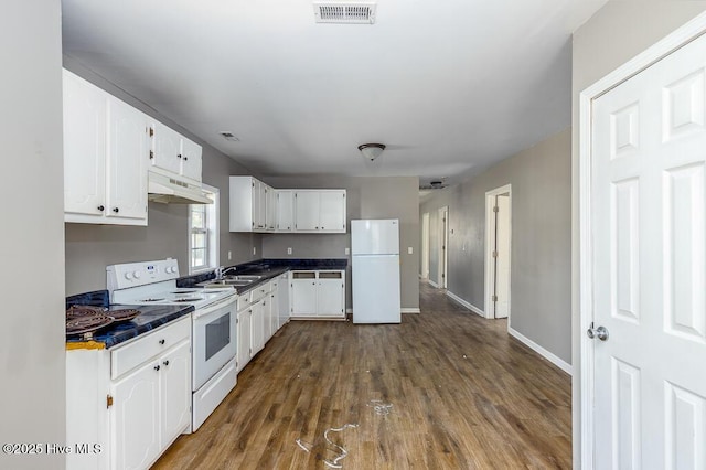 kitchen featuring under cabinet range hood, white appliances, a sink, visible vents, and white cabinets