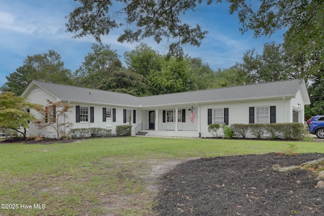 ranch-style house with covered porch and a front lawn