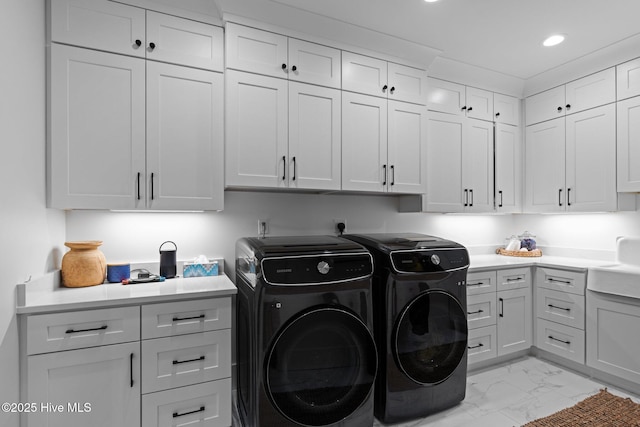 washroom with marble finish floor, washer and clothes dryer, cabinet space, and recessed lighting