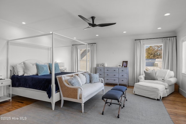 bedroom featuring recessed lighting, multiple windows, ceiling fan, and wood finished floors