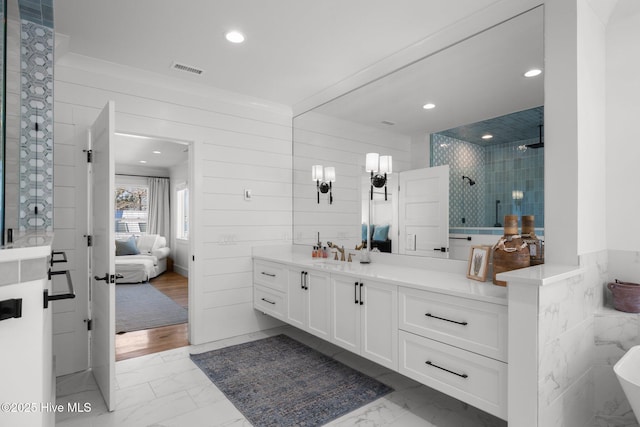 full bathroom featuring marble finish floor, connected bathroom, vanity, and a shower stall