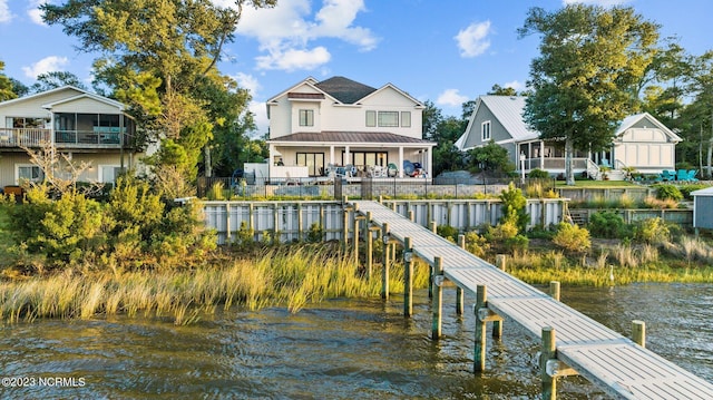 dock area featuring a water view and fence