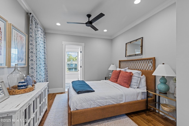 bedroom featuring crown molding, wood finished floors, and recessed lighting