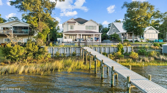 dock area with a water view and fence