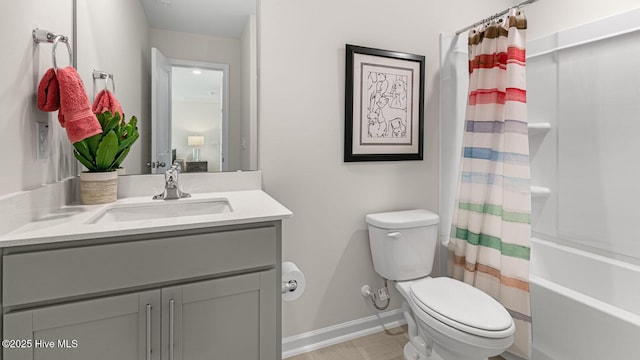 bathroom featuring toilet, baseboards, shower / tub combo with curtain, and vanity