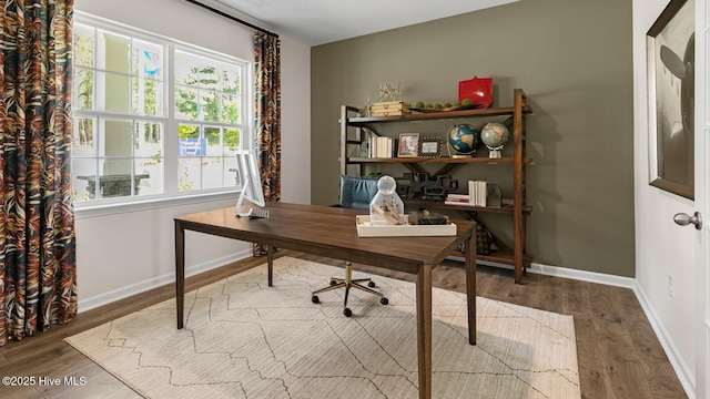 home office featuring baseboards and wood finished floors