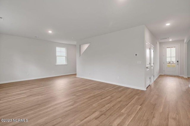 spare room featuring recessed lighting, visible vents, baseboards, and light wood-style floors