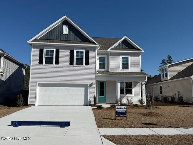 view of front of property with a garage, board and batten siding, and driveway