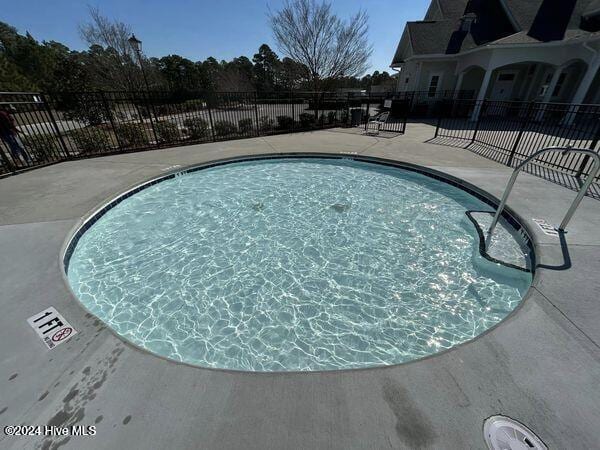 pool featuring a patio and fence