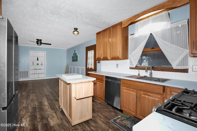 kitchen with dark wood-style floors, visible vents, a sink, a textured ceiling, and dishwasher