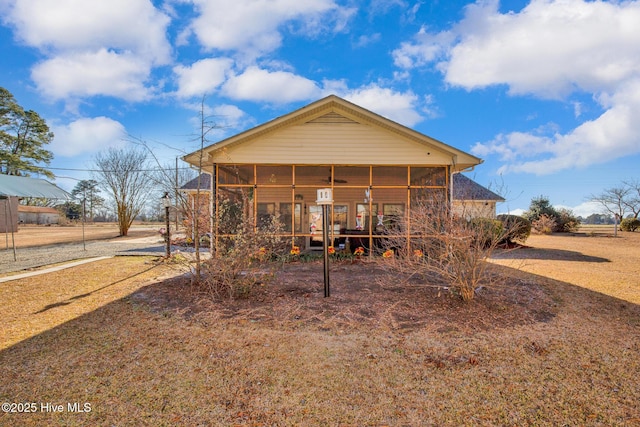 rear view of property with a sunroom