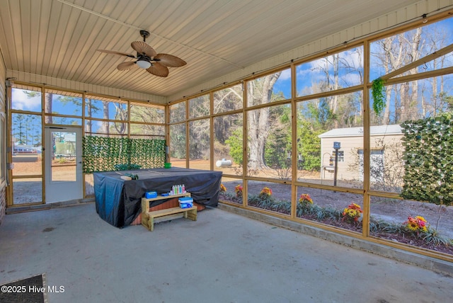 unfurnished sunroom featuring ceiling fan