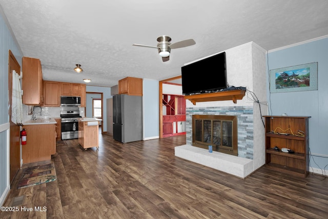 interior space featuring stainless steel appliances, dark wood finished floors, light countertops, and a sink