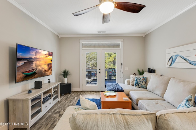 living room featuring french doors, ornamental molding, wood finished floors, and visible vents