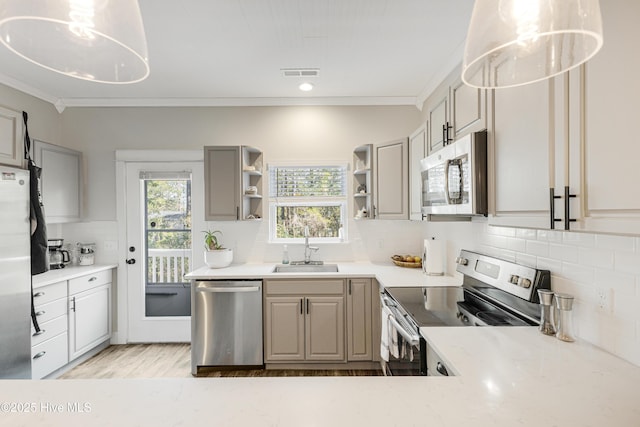 kitchen featuring visible vents, appliances with stainless steel finishes, ornamental molding, open shelves, and a sink