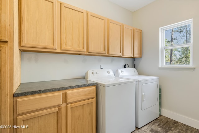 laundry room with cabinet space, dark wood finished floors, washer and clothes dryer, and baseboards