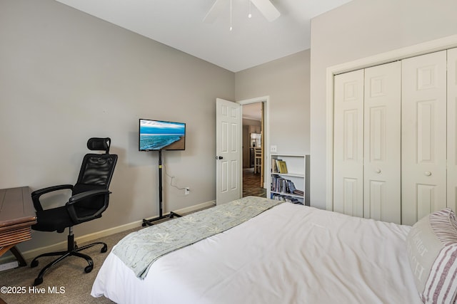 bedroom featuring a ceiling fan, a closet, carpet flooring, and baseboards