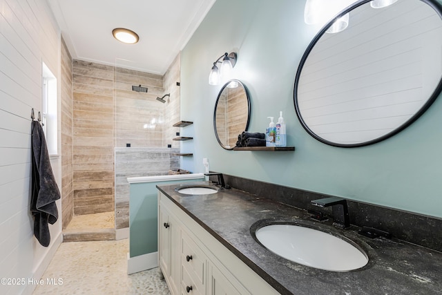 bathroom with double vanity, a sink, and walk in shower