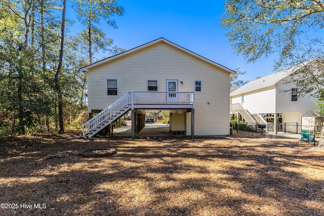 back of house with fence, stairway, and a wooden deck