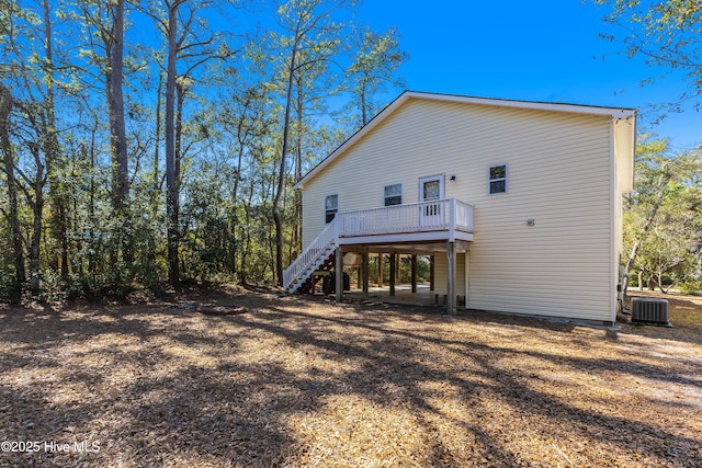 back of house featuring stairs, a deck, and cooling unit