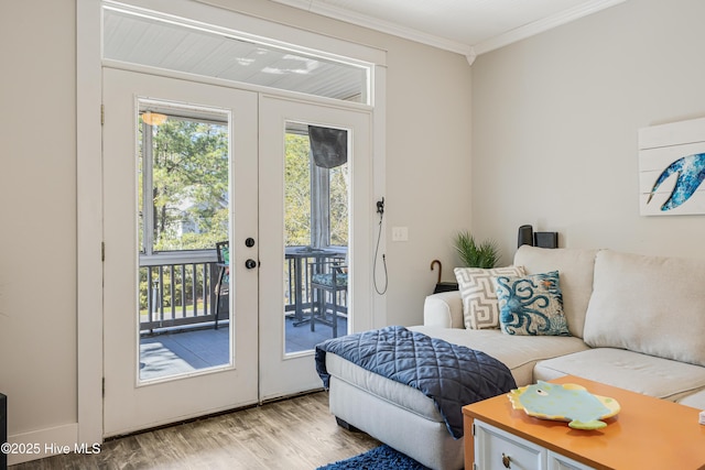 interior space featuring french doors, light wood finished floors, and crown molding