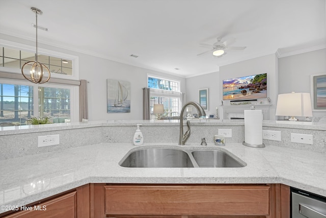 kitchen featuring ornamental molding, brown cabinetry, a sink, and visible vents