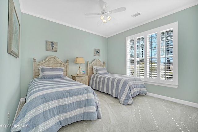 carpeted bedroom with baseboards, a ceiling fan, visible vents, and crown molding